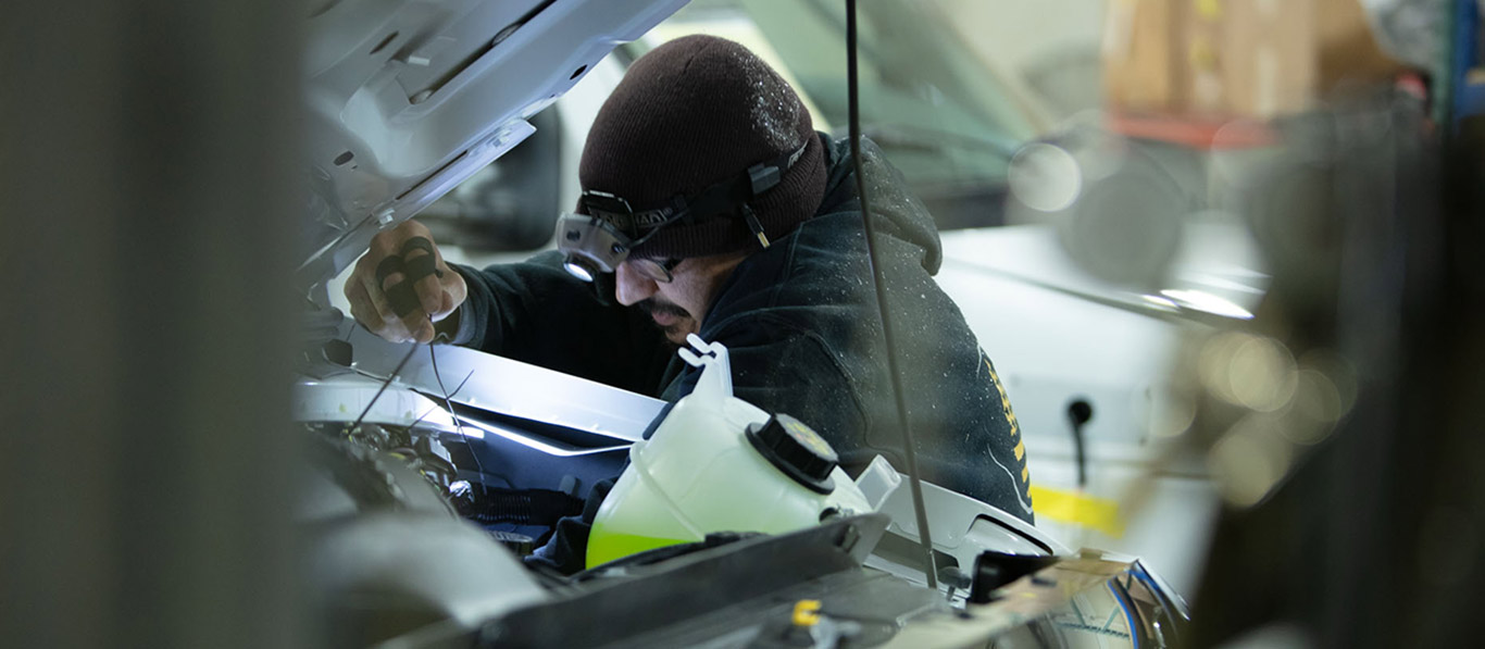 Medix Ambulance mechanic working on engine